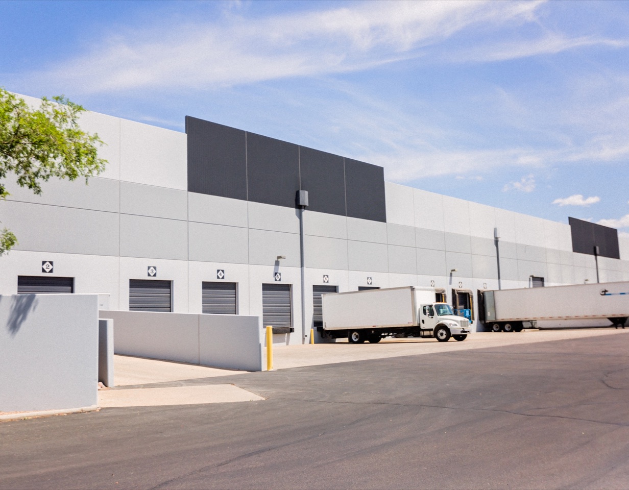 Exterior of SKU Distribution's Foreign Trade Zone warehouse in Mesa, Arizona, with trucks at the loading docks